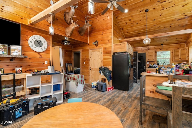 dining area with ceiling fan, dark wood-type flooring, beamed ceiling, and wood ceiling