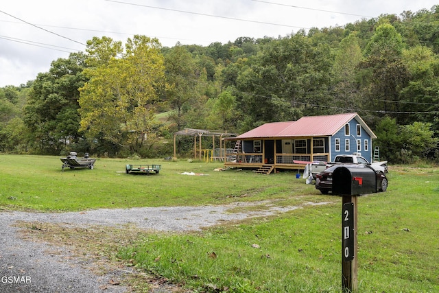 view of front of home with a porch and a front lawn