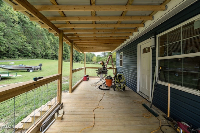 wooden deck featuring a lawn