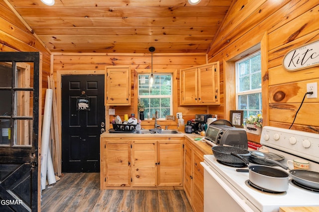 kitchen featuring white range with electric stovetop, light brown cabinetry, vaulted ceiling, and decorative light fixtures