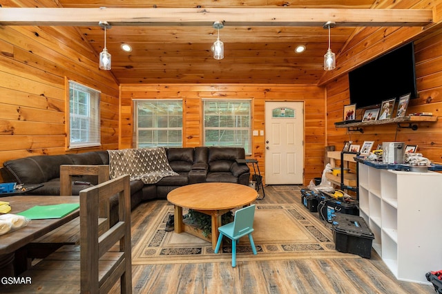 living room with hardwood / wood-style floors, lofted ceiling with beams, wood walls, and wood ceiling