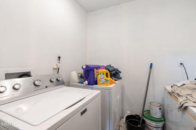 clothes washing area with separate washer and dryer