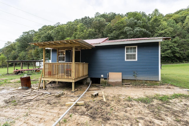 rear view of property with a pergola and a wooden deck