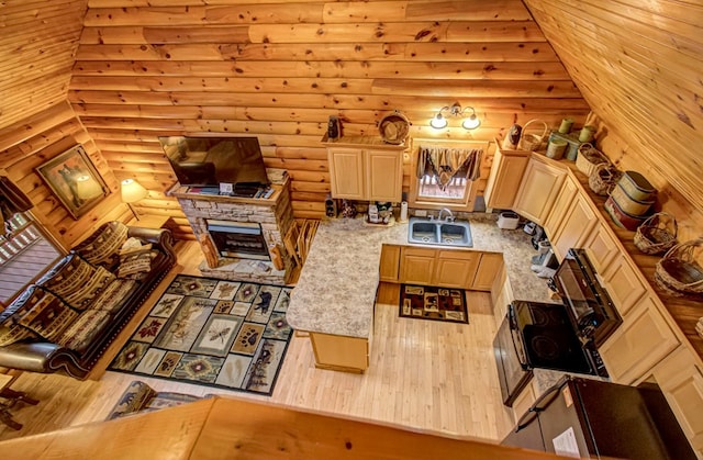 living room featuring log walls, a fireplace, and sink