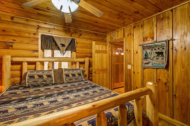 bedroom with rustic walls and ceiling fan