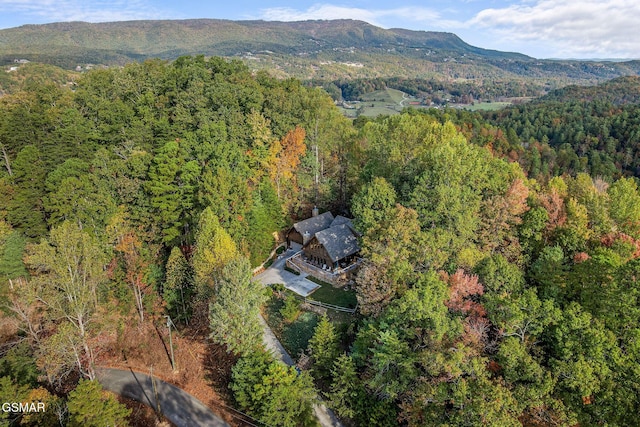 aerial view with a wooded view and a mountain view