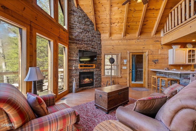 living area featuring plenty of natural light, wood finished floors, and wooden walls