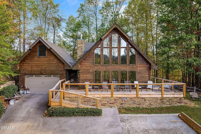 chalet / cabin with a garage and a chimney