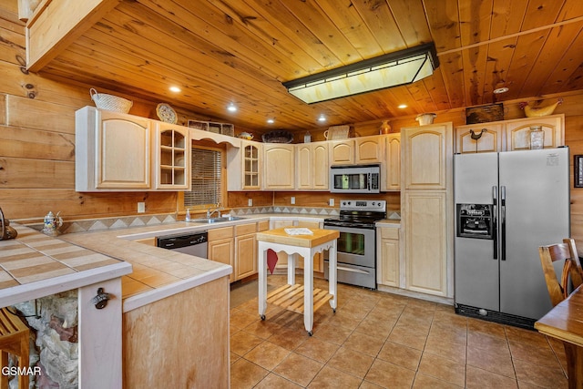 kitchen with tile countertops, wood ceiling, appliances with stainless steel finishes, light brown cabinets, and light tile patterned flooring