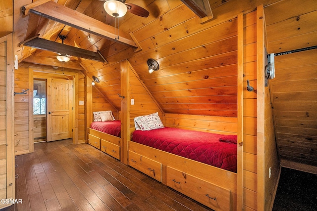 bedroom with lofted ceiling with beams, wood walls, wood-type flooring, and wood ceiling