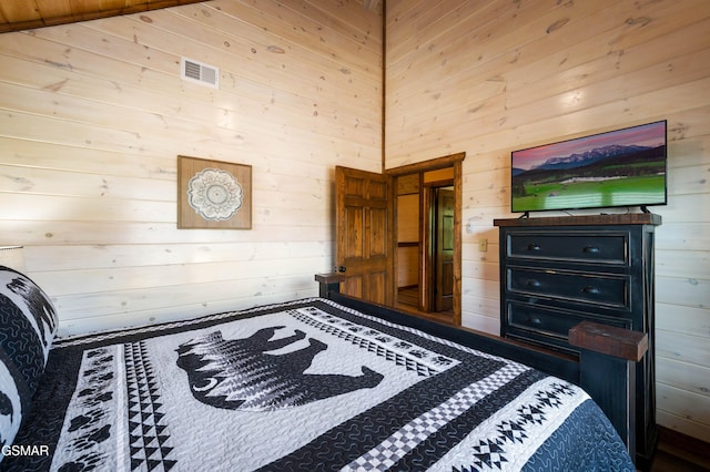 bedroom featuring wooden walls