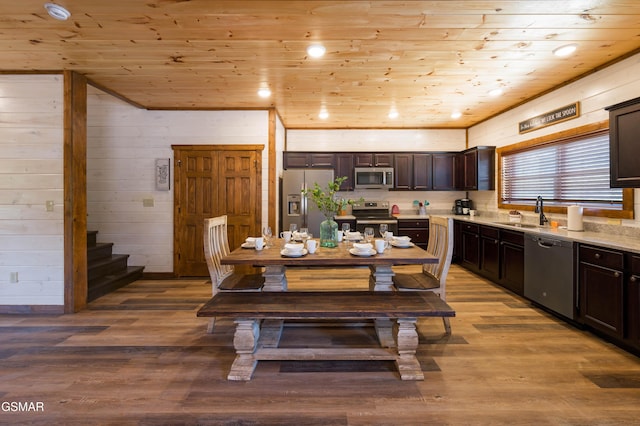 dining area featuring wooden walls, sink, light hardwood / wood-style floors, and wooden ceiling