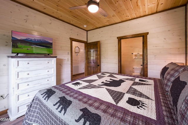 bedroom featuring ensuite bathroom, wooden ceiling, and wood walls