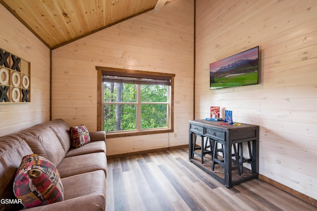 living room featuring lofted ceiling, wood-type flooring, wooden ceiling, and wooden walls