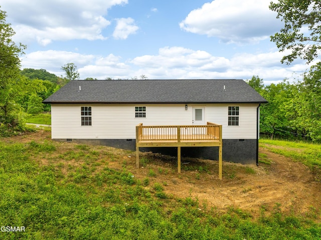 back of house with crawl space and a deck