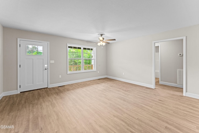 unfurnished living room featuring light wood-style floors, ceiling fan, and baseboards