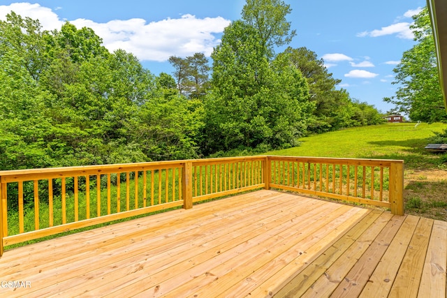 wooden terrace featuring a yard