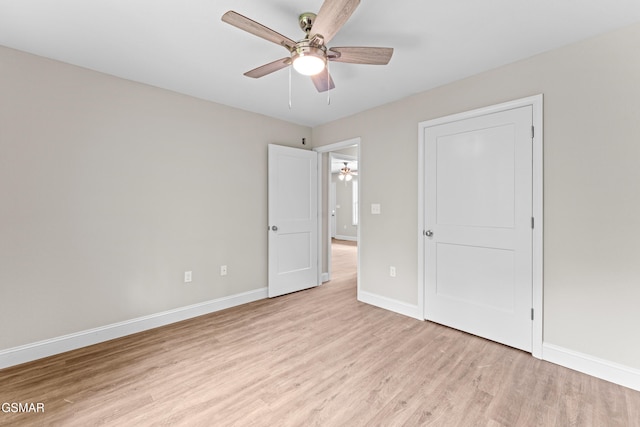unfurnished bedroom with light wood-style floors, baseboards, and a ceiling fan