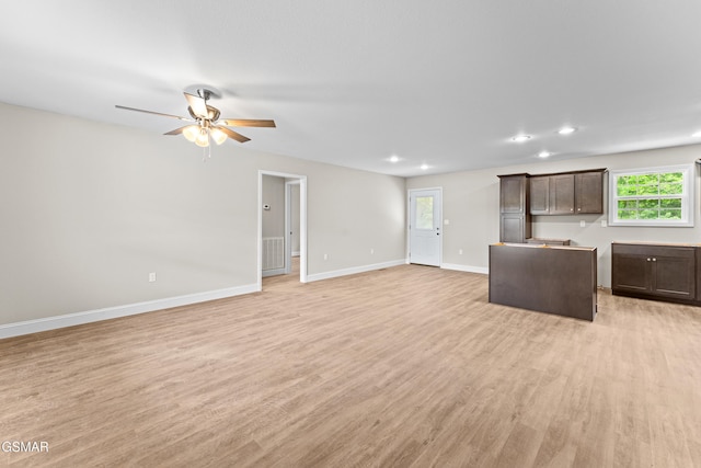 unfurnished living room featuring light wood-style flooring, a ceiling fan, baseboards, and recessed lighting
