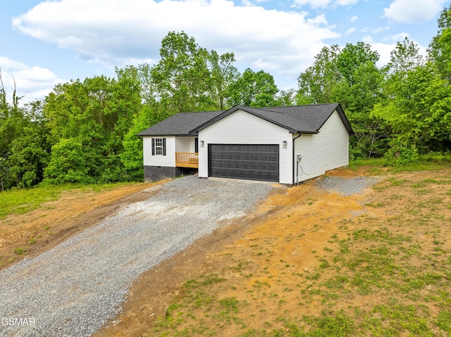 view of front of house with gravel driveway and an attached garage