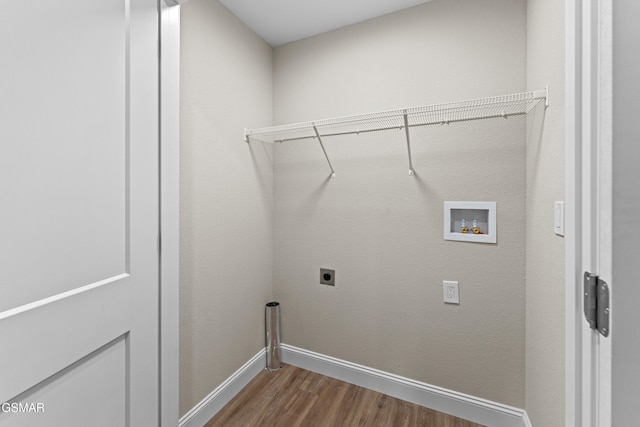 washroom with washer hookup, electric dryer hookup, wood finished floors, and baseboards