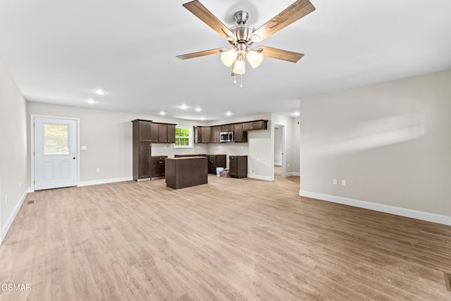 unfurnished living room with baseboards, light wood-style flooring, a ceiling fan, and recessed lighting