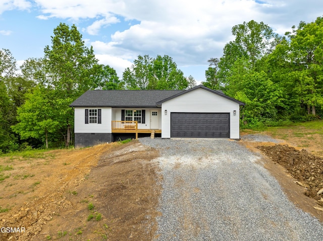 view of front of home featuring gravel driveway, an attached garage, and crawl space