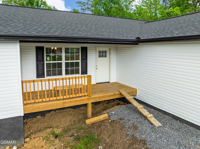 property entrance with roof with shingles