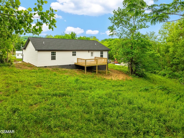 back of property with crawl space and a deck