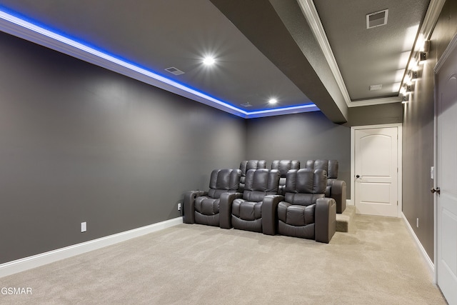 carpeted home theater featuring crown molding