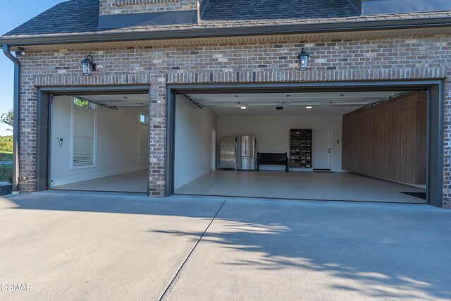 garage with stainless steel fridge