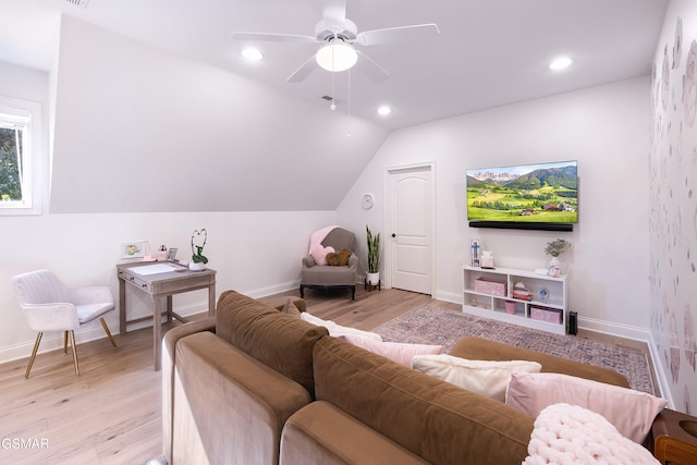 living room featuring ceiling fan, light hardwood / wood-style flooring, and lofted ceiling