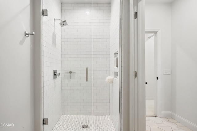 bathroom featuring tile patterned flooring and an enclosed shower