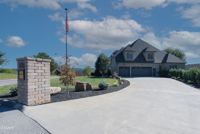 view of front of house with a garage and a front lawn