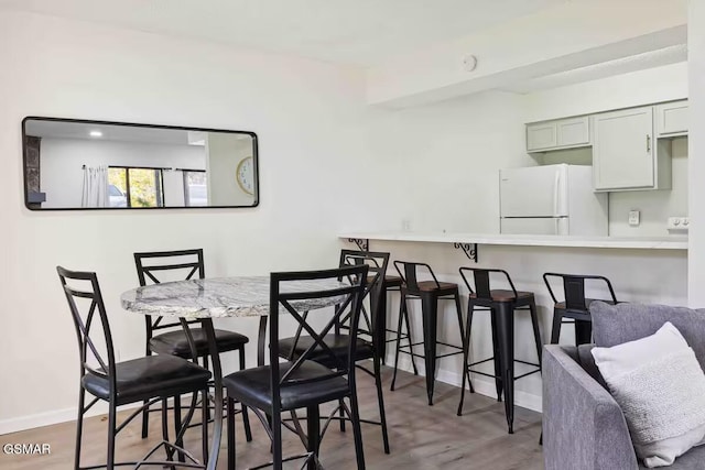 dining area with wood-type flooring