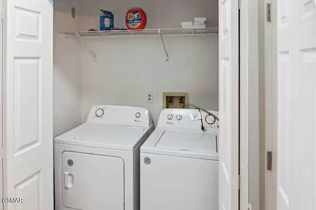 clothes washing area featuring separate washer and dryer