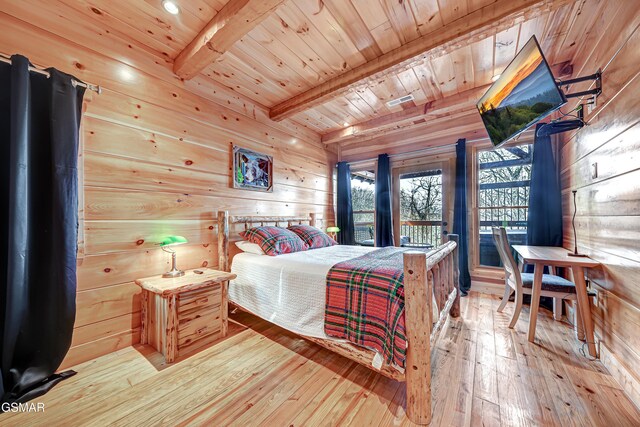 bedroom featuring beamed ceiling, wooden walls, light hardwood / wood-style floors, and wooden ceiling