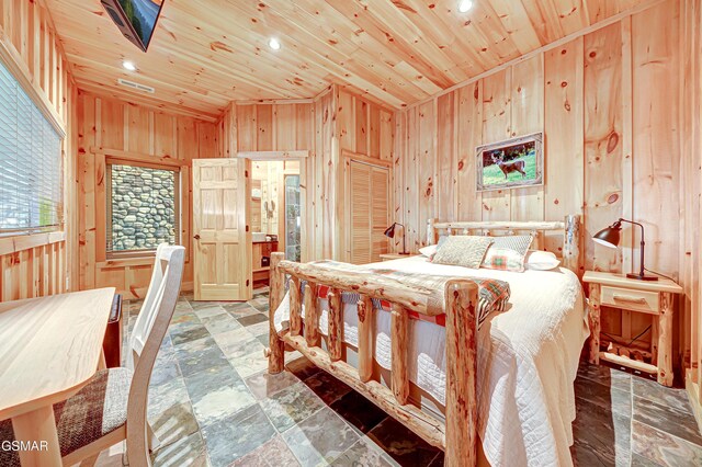 bedroom with wooden ceiling and wooden walls