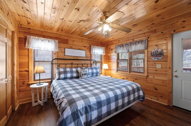 bedroom with multiple windows, wood walls, dark hardwood / wood-style flooring, and wood ceiling