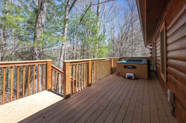 wooden deck with a hot tub