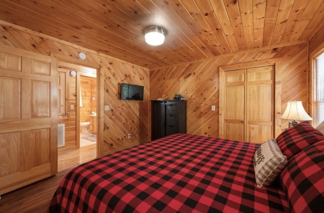 bedroom featuring ensuite bathroom, a closet, wooden ceiling, and wood walls