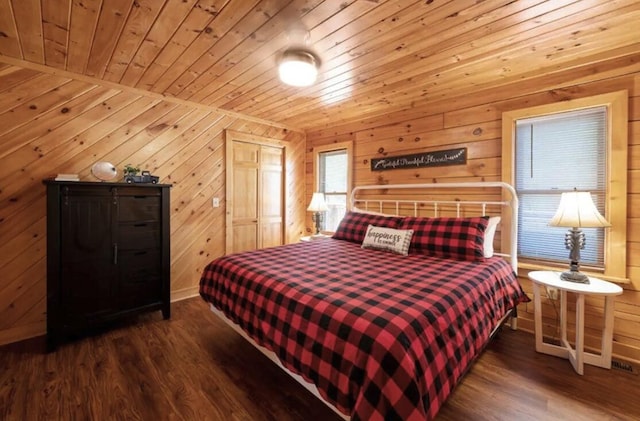 bedroom with wooden walls, dark hardwood / wood-style floors, and wooden ceiling