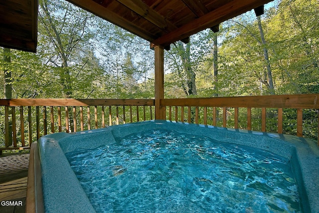 wooden deck with a hot tub