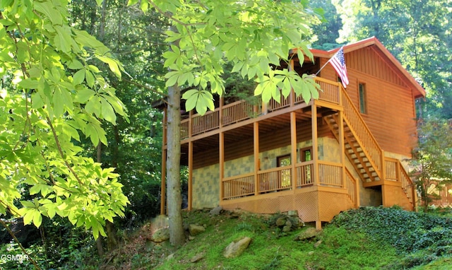 exterior space featuring stairs and a wooden deck