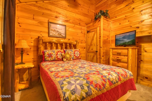 bedroom featuring wooden walls and carpet