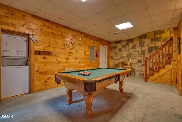 playroom featuring a paneled ceiling, stacked washer and clothes dryer, pool table, and wooden walls