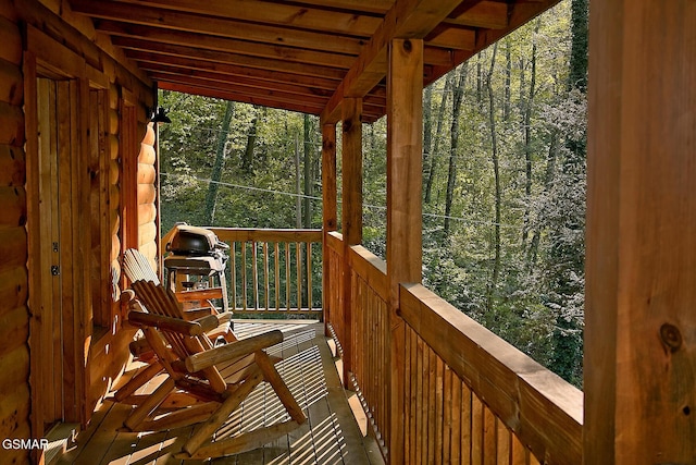 wooden deck featuring a forest view