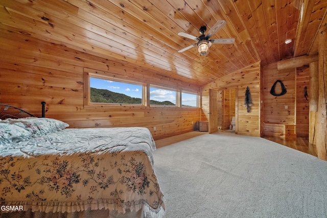 carpeted bedroom with a mountain view, wooden walls, vaulted ceiling, ceiling fan, and wood ceiling