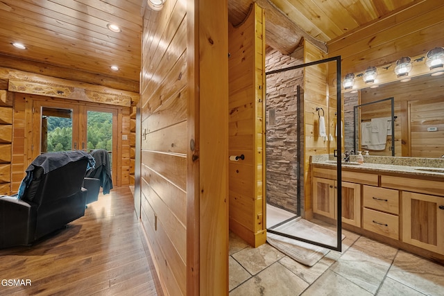 bathroom with vanity, wooden ceiling, wooden walls, and french doors