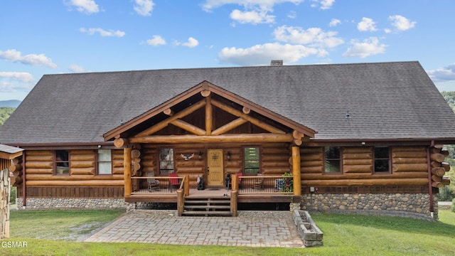 rear view of property featuring a yard